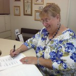 Photo: Declaration signing Marilyn Lubarsky, Co-chair